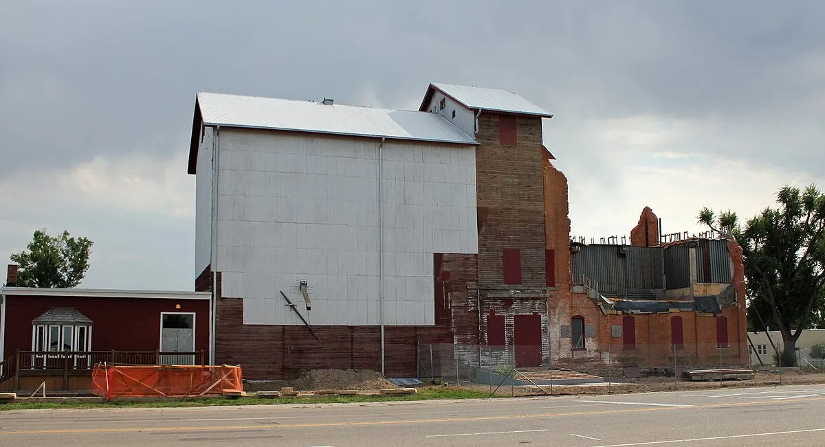 The Windsor Milling and Elevator Company building at 301 Main Street in August 2012, its white elevator and brick mill under reconstruction