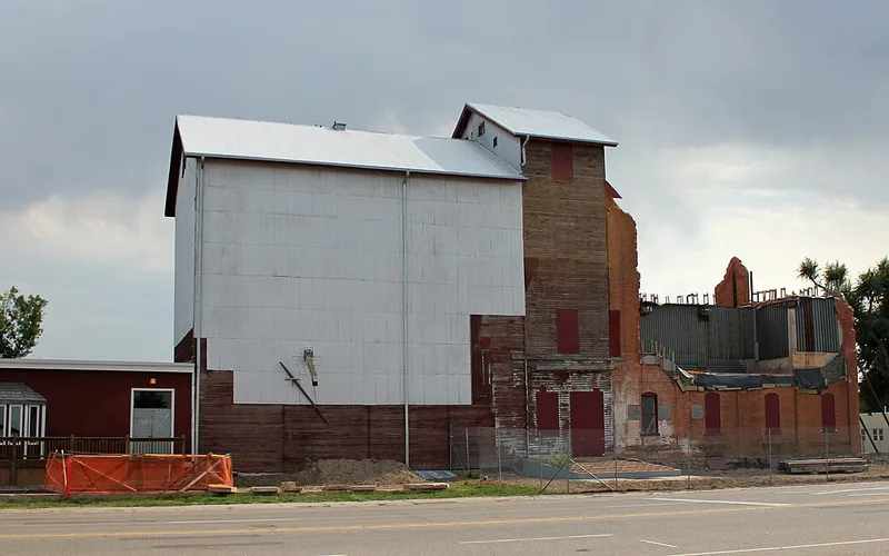 The Windsor Milling and Elevator Company building at 301 Main Street in August 2012, its white elevator and brick mill under reconstruction