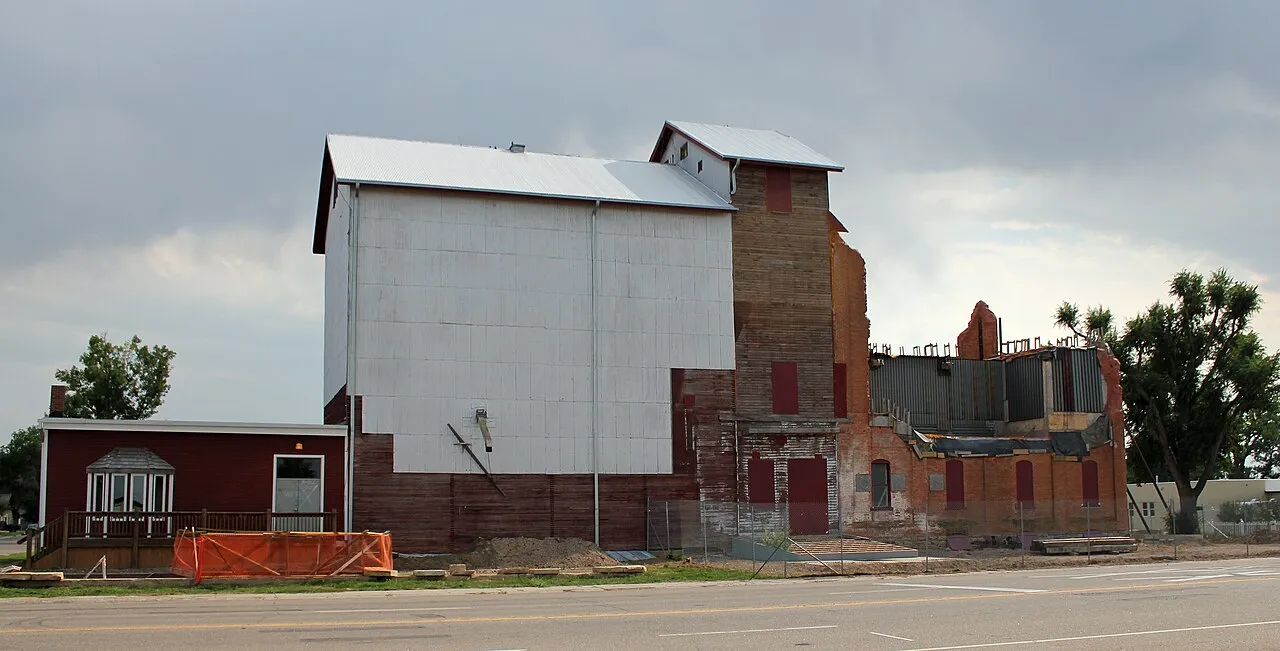 The Windsor Milling and Elevator Company building at 301 Main Street in August 2012, its white elevator and brick mill under reconstruction
